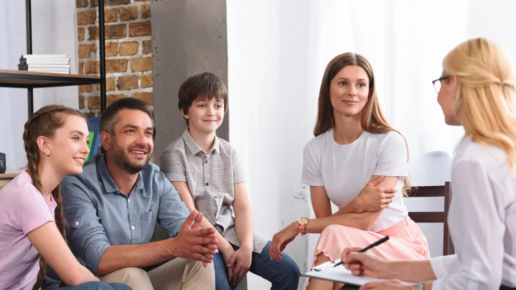 A psychotherapist leads a family therapy session.