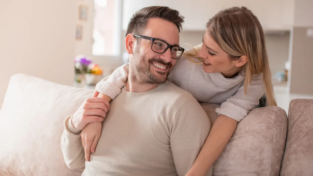 A couple embrace and look at each other.